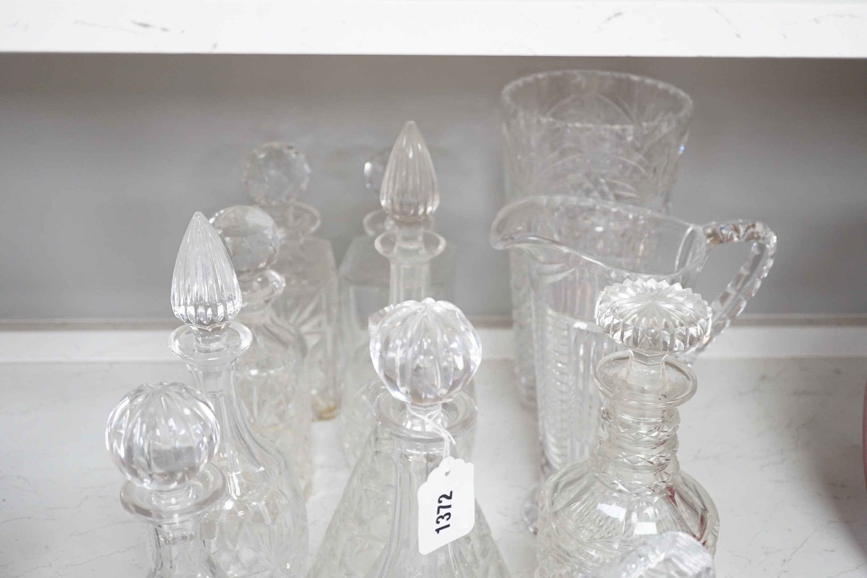 A group of assorted glass decanters and two vases